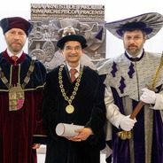 Three men standing in full academic regalia - Dr. Jain is in the center wearing a medal and holding his honorary doctorate