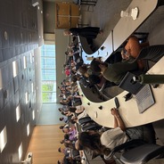 Nancy Gray speaking to a room full of attendees at the symposium